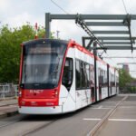 Rood-witte HTM-tram op de Sebastiaansbrug in Delft; illustratieve bedrijfsfoto